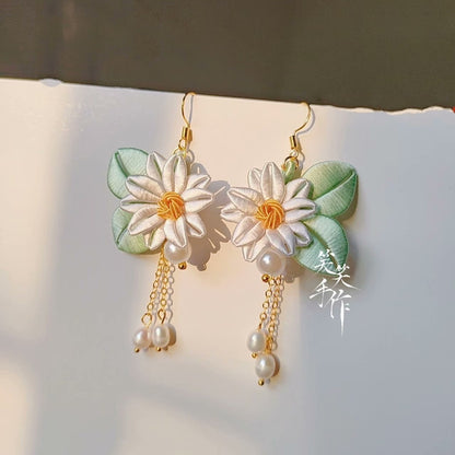 Elegant Chanhua flower and pearl drop earrings featuring white flowers, light green leaves, and genuine freshwater pearls hanging from 925 silver hooks.