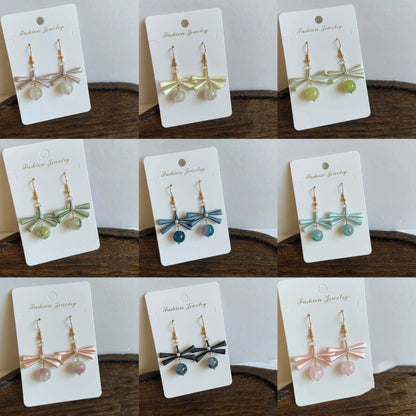 A collage of nine handmade Chanhua earrings in various colors, including pink, yellow, green, and blue, showcasing the full collection.