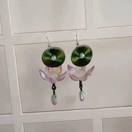 Elegant handcrafted earrings with a lotus and a leaf design, made from Chanhua fabric, photographed against a clean background.