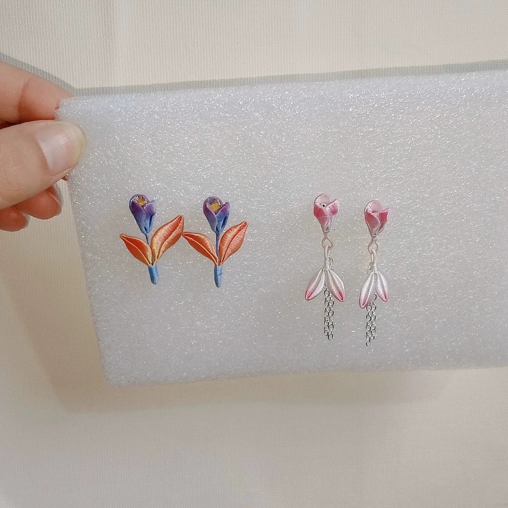 Close-up of handmade Chanhua flower drop earrings with 925 sterling silver hooks.