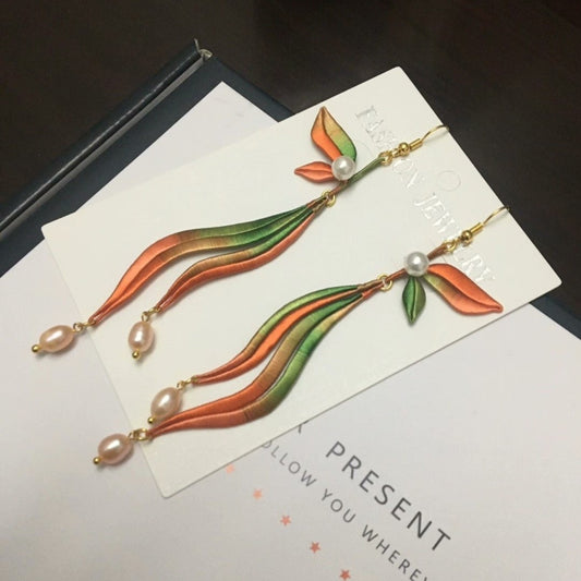 Handmade Chanhua silk dangle earrings with orange, green, and pink gradient and freshwater pearls