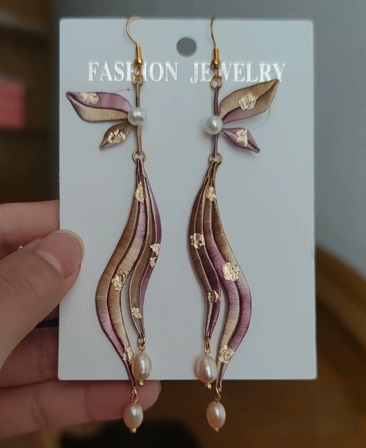 Unique handmade Chanhua earrings featuring purple and gold-flecked silk and natural pearls