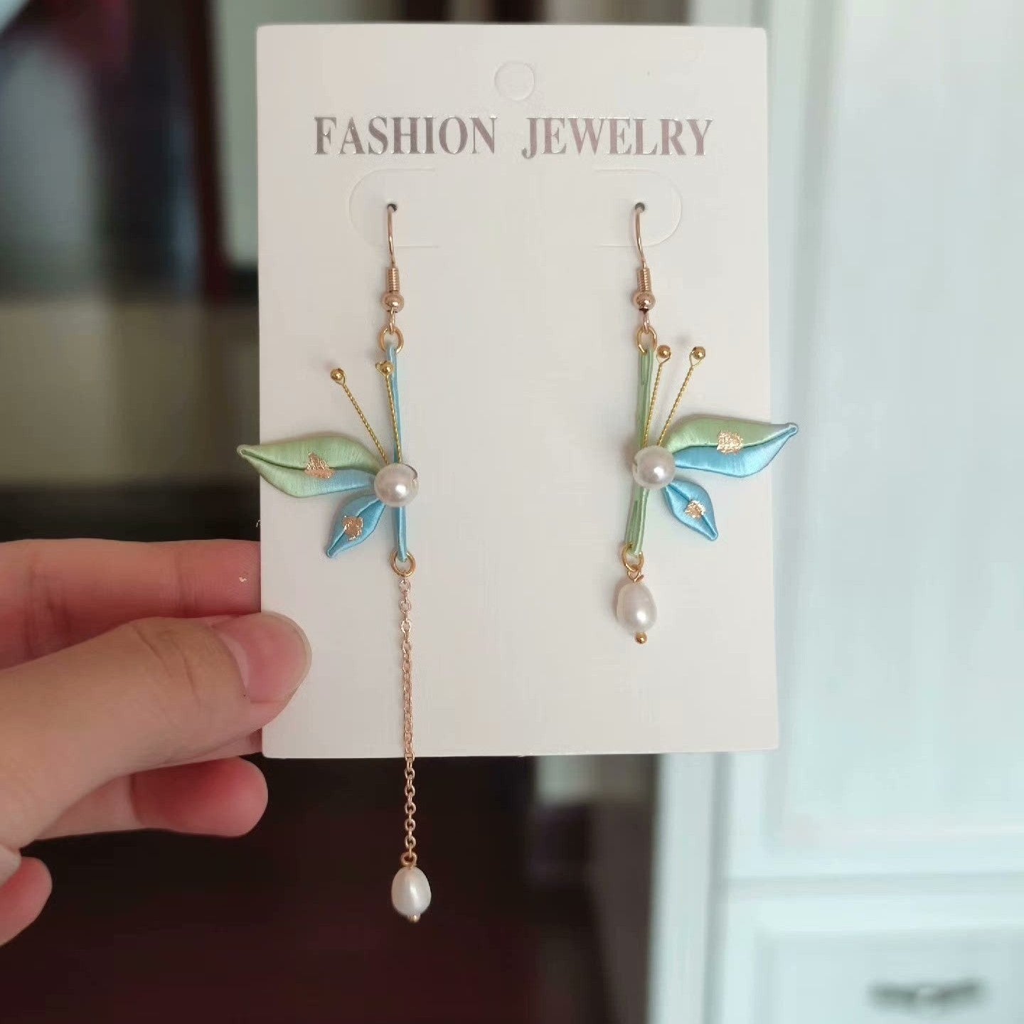 Handcrafted Chanhua butterfly earrings with blue and green silk wings and freshwater pearls.