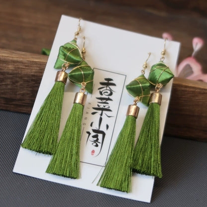Pair of Zongzi-inspired green tassel earrings with 925 silver hooks, displayed on a card with Chinese characters.