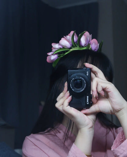Side view of a handcrafted velvet tulip flower crown worn by a person, highlighting the detailed floral arrangement and comfortable fit.