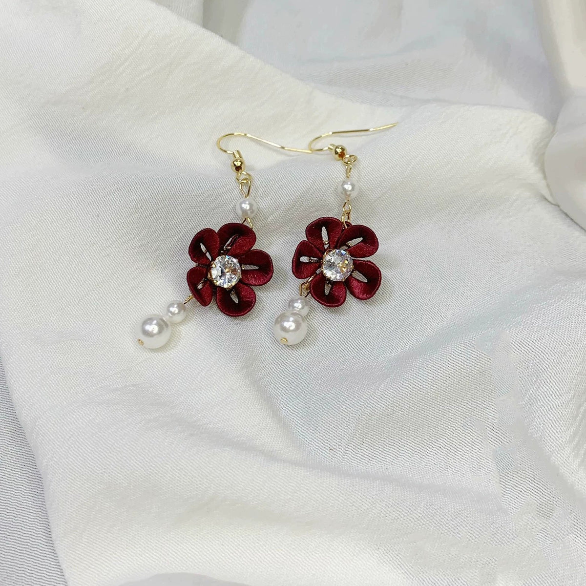 Handmade burgundy red Chanhua flower earrings featuring a central rhinestone and freshwater pearl details, ideal for evening wear.