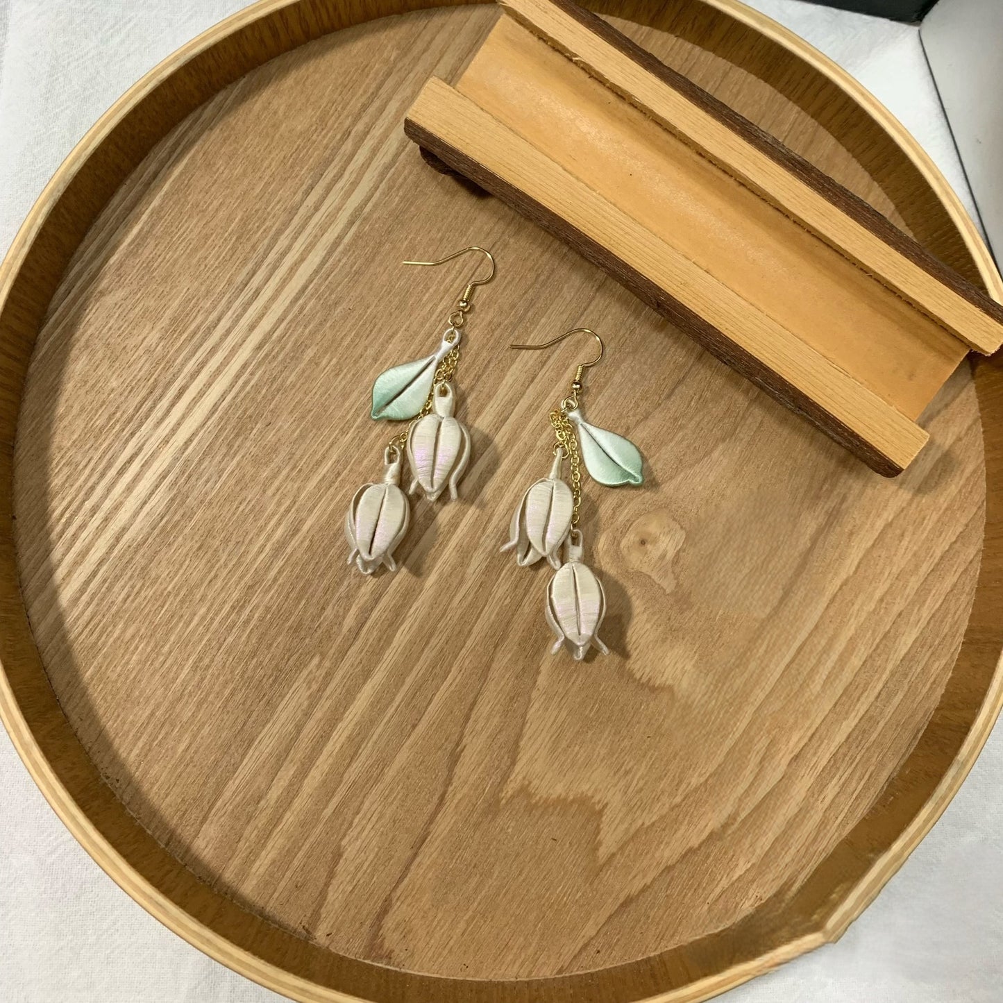 Handmade Chanhua lily of the valley earrings with thread bell flowers and green leaves, dangling floral drop earrings