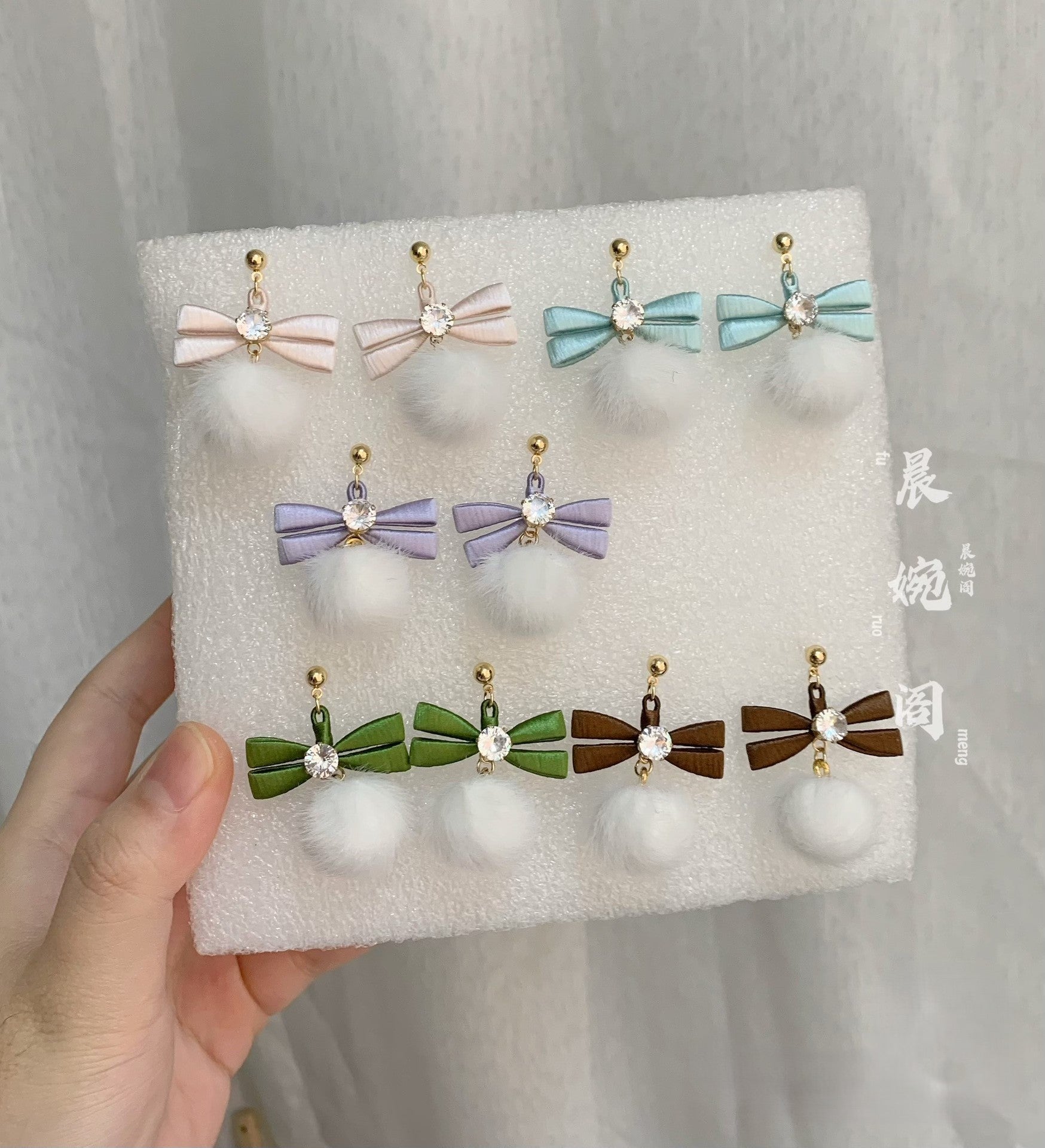 Handmade Chanhua bow pom pom earrings set in 5 colors (pink, peach, blue, purple, green/brown), thread bow drop earrings with crystal and fluffy pom pom