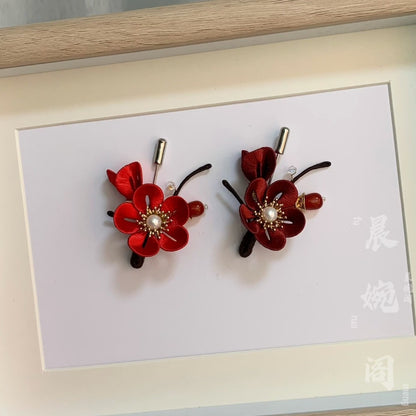 Handmade Chanhua red plum blossom brooch pair in thread petals with pearl centers, gold leaves, red berries, and crystal accents, elegant floral lapel pins