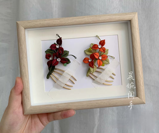 Handmade Chanhua bougainvillea hair comb in red and orange thread flowers with green leaves, pearl accents, and gold comb base, elegant floral hair accessory