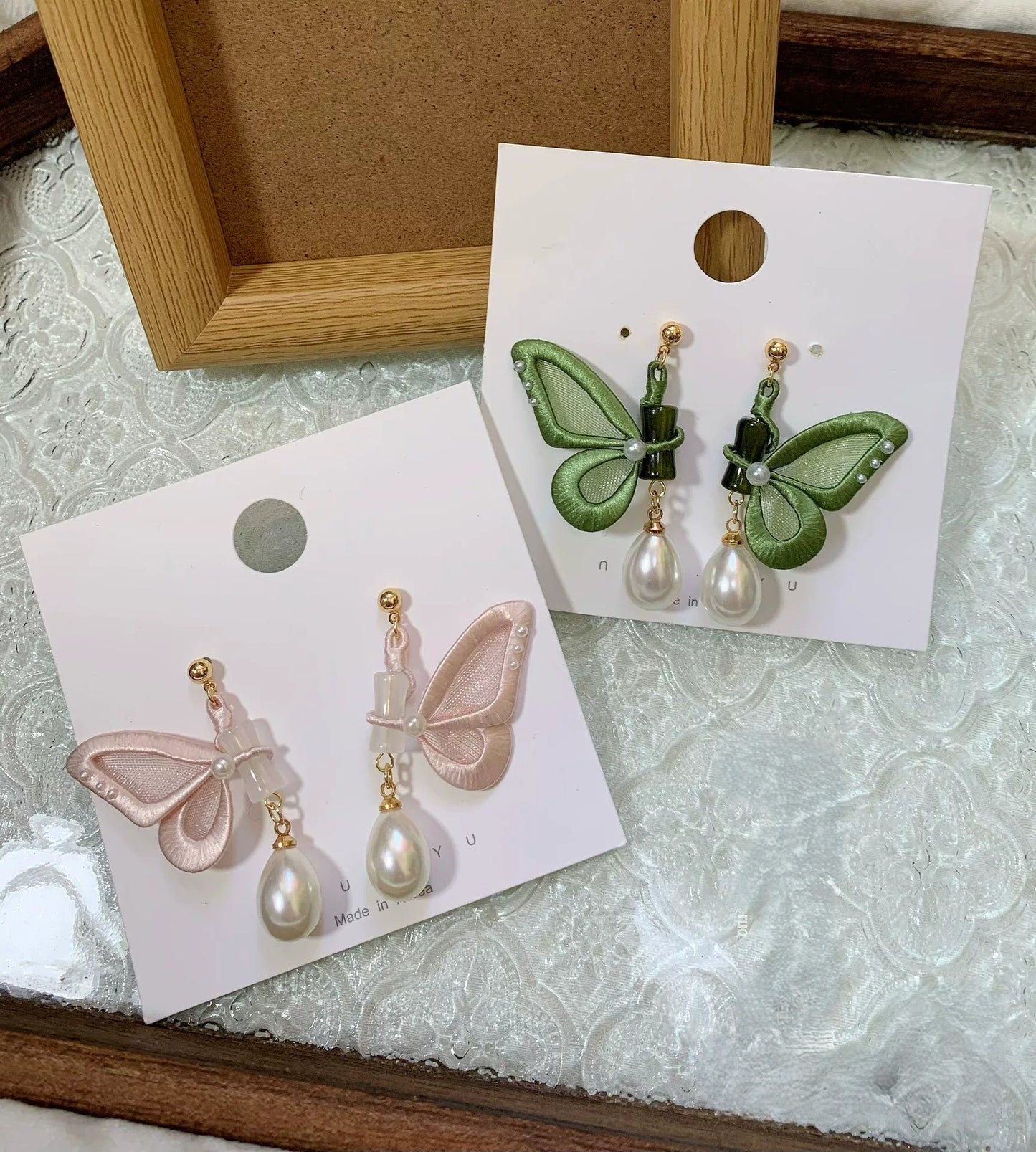 Handmade Chanhua butterfly stud earrings in pink and green thread wings with pearl teardrop pendants, elegant dangling pearl butterfly earrings