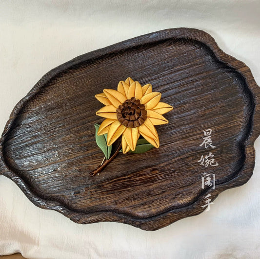 Handmade Chanhua sunflower brooch in yellow thread petals with brown center and green leaves, elegant floral lapel pin