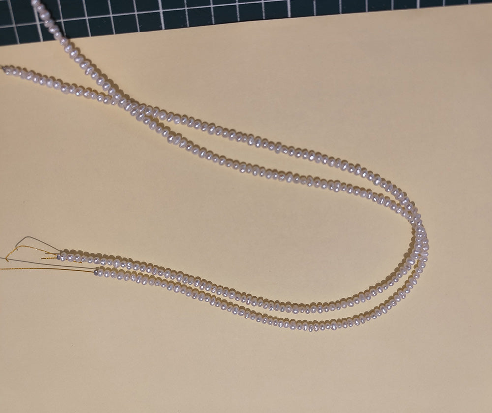 Detail shot of natural freshwater pearls, highlighting their luster and varied shapes.