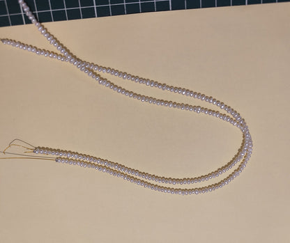 Detail shot of natural freshwater pearls, highlighting their luster and varied shapes.