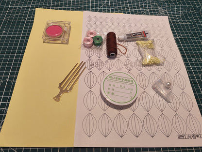 DIY flower craft supply kit including pink and green threads, copper wire, blush powder for shading, glue, templates, and a metal hair comb.
