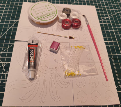 An overhead view of the Chanhua DIY kit contents, including silk threads, copper wire, glue, and nine-tailed fox design templates.