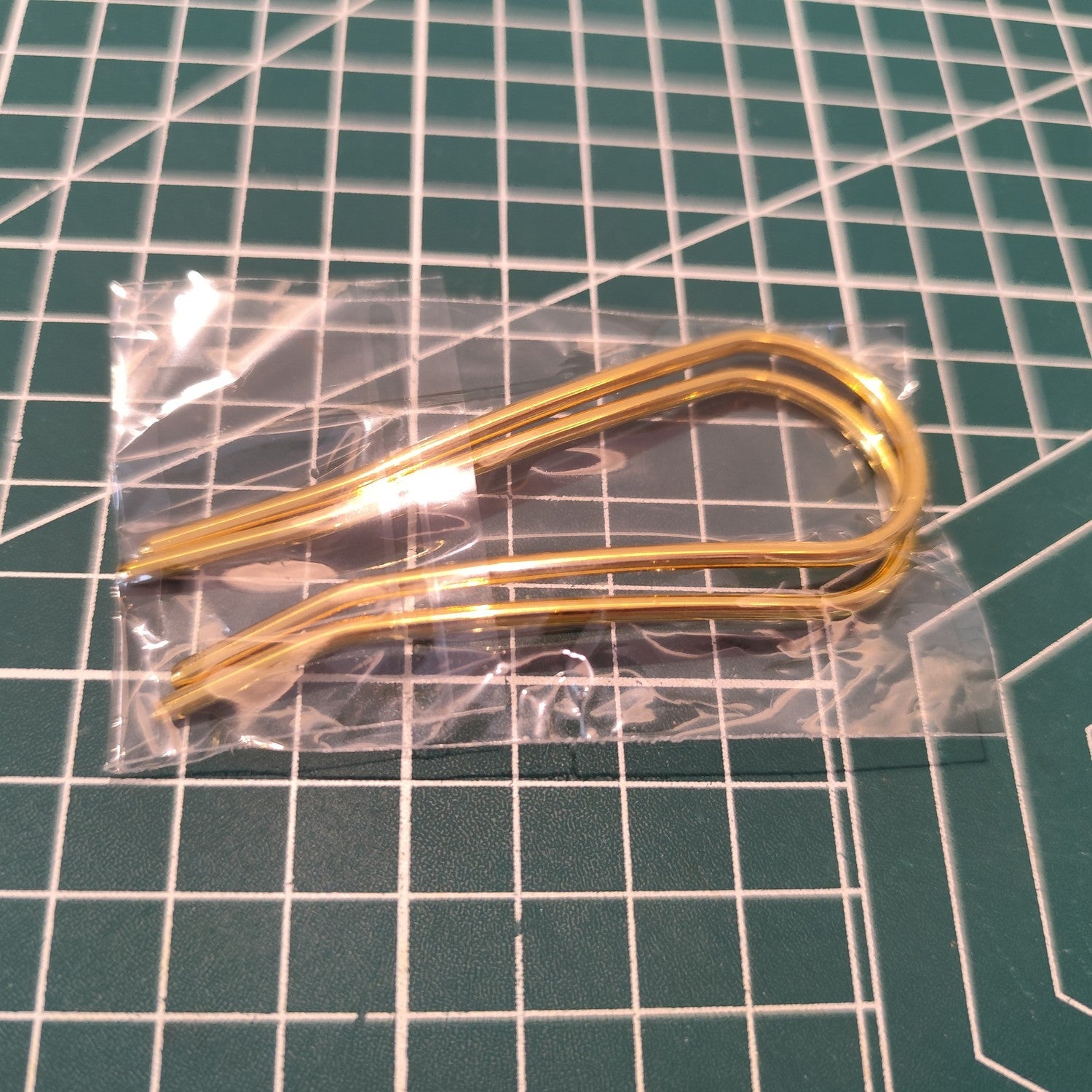 Packaged pair of 80mm x 30mm U-shaped hair pins in clear plastic sleeve, highlighting their sleek design for handmade hairstyles.
