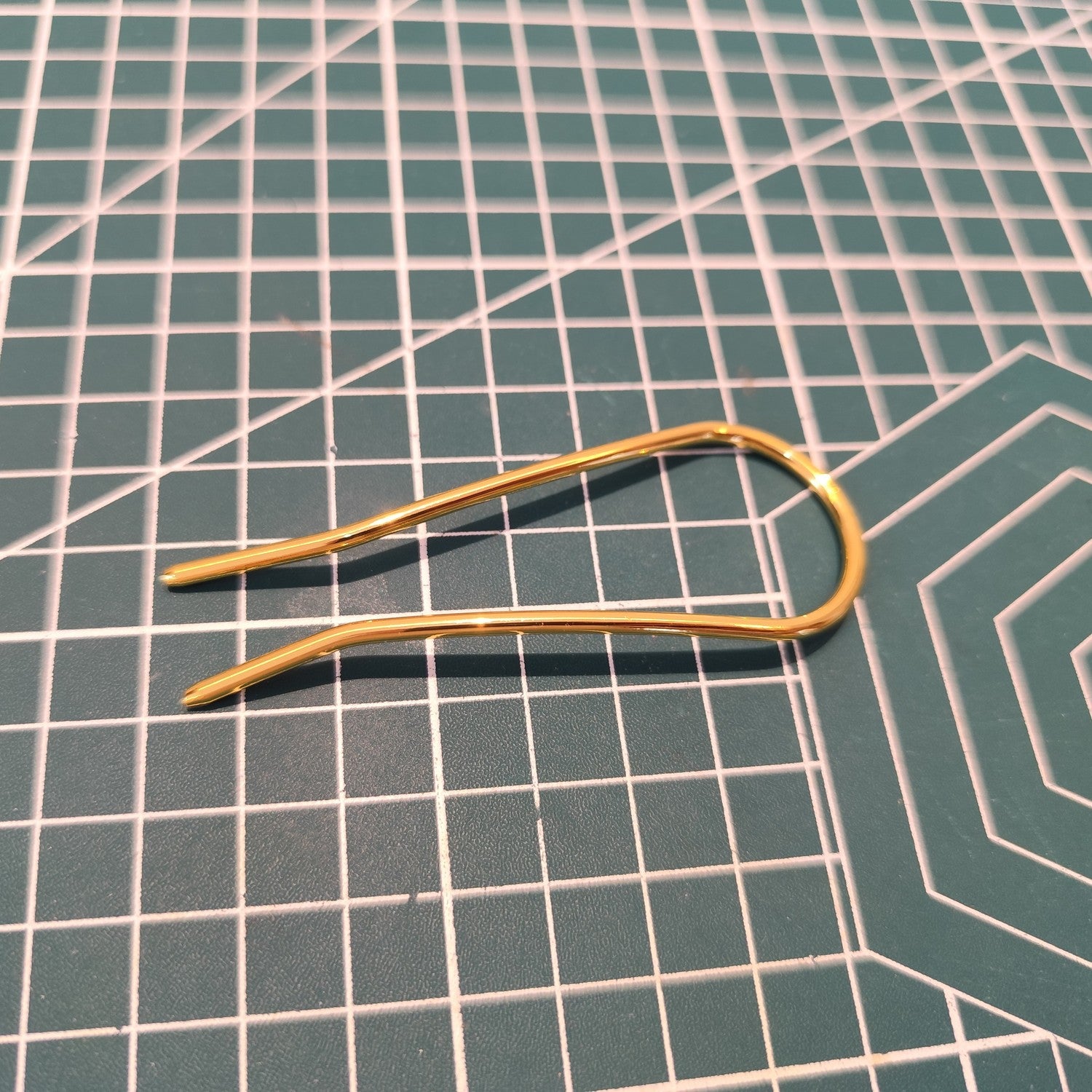 Angled view of U-shaped alloy hair pins demonstrating bendable structure, suitable as DIY hair accessory bases or direct updo clips.