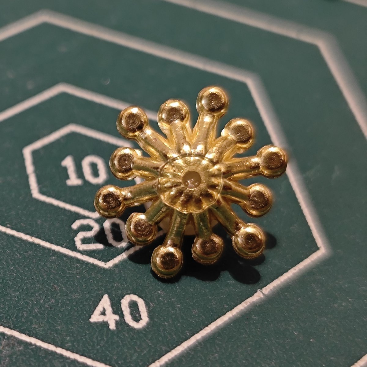 Back view of metal flower embellishment showing structure for mounting or wiring.