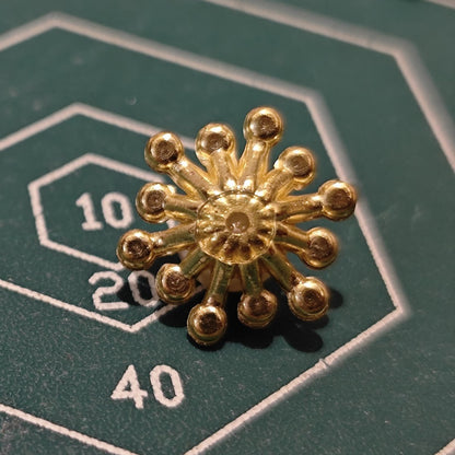 Back view of metal flower embellishment showing structure for mounting or wiring.