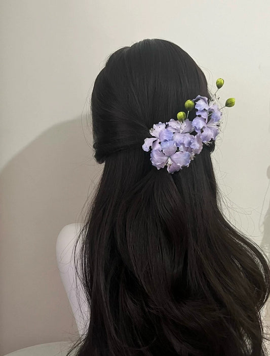 Image (Half-Up Hairstyle): Handcrafted lilac mulberry silk Ronghua flower hair clip securing a dark, flowing half-up hairstyle, ideal for a subtle formal look.