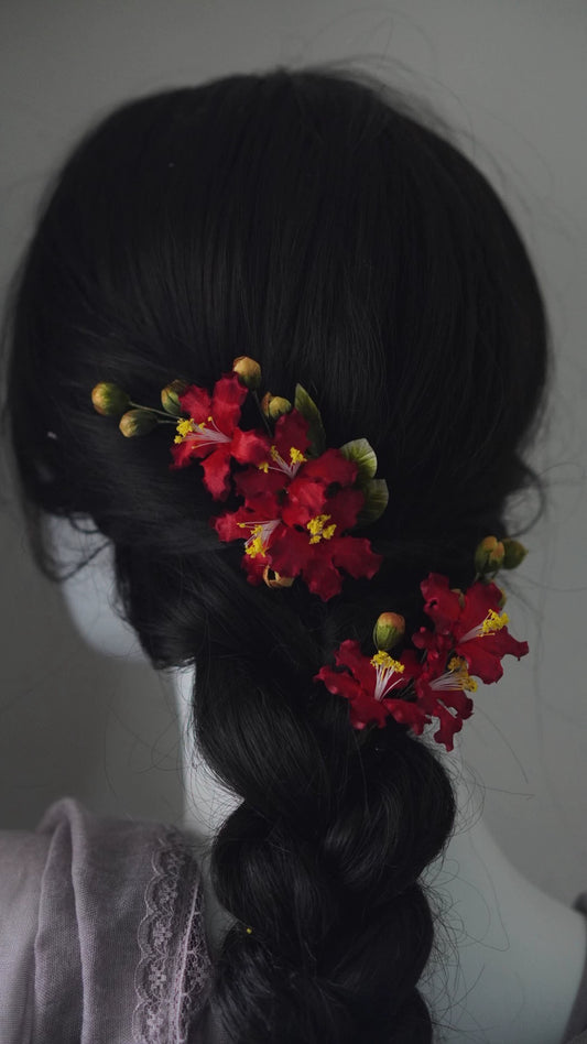 Handcrafted red Crape Myrtle Ronghua silk hair clips set securing a dark braided ponytail.