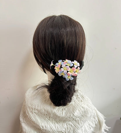 Handmade silk hydrangea Ronghua hair clip attached to a hair bun on a mannequin