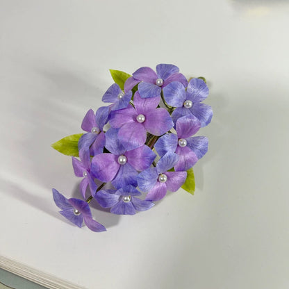 Front close-up of purple hydrangea Ronghua hair accessory on white background
