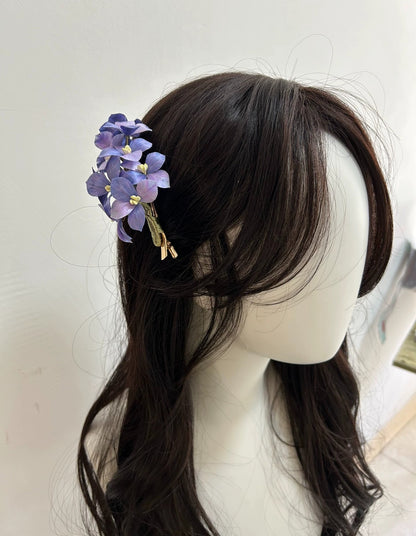 Two handmade purple hydrangea flower hair clips in natural silk thread on white background.