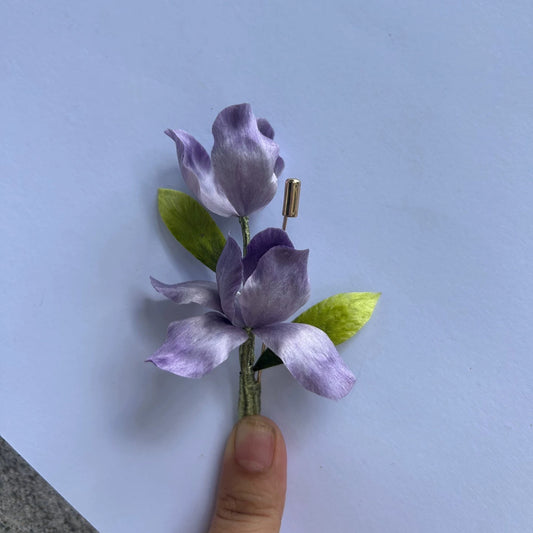 Handmade purple iris Ronghua velvet flower brooch pin held in hand – luxury silk floral jewelry with natural mulberry silk petals and gold pin