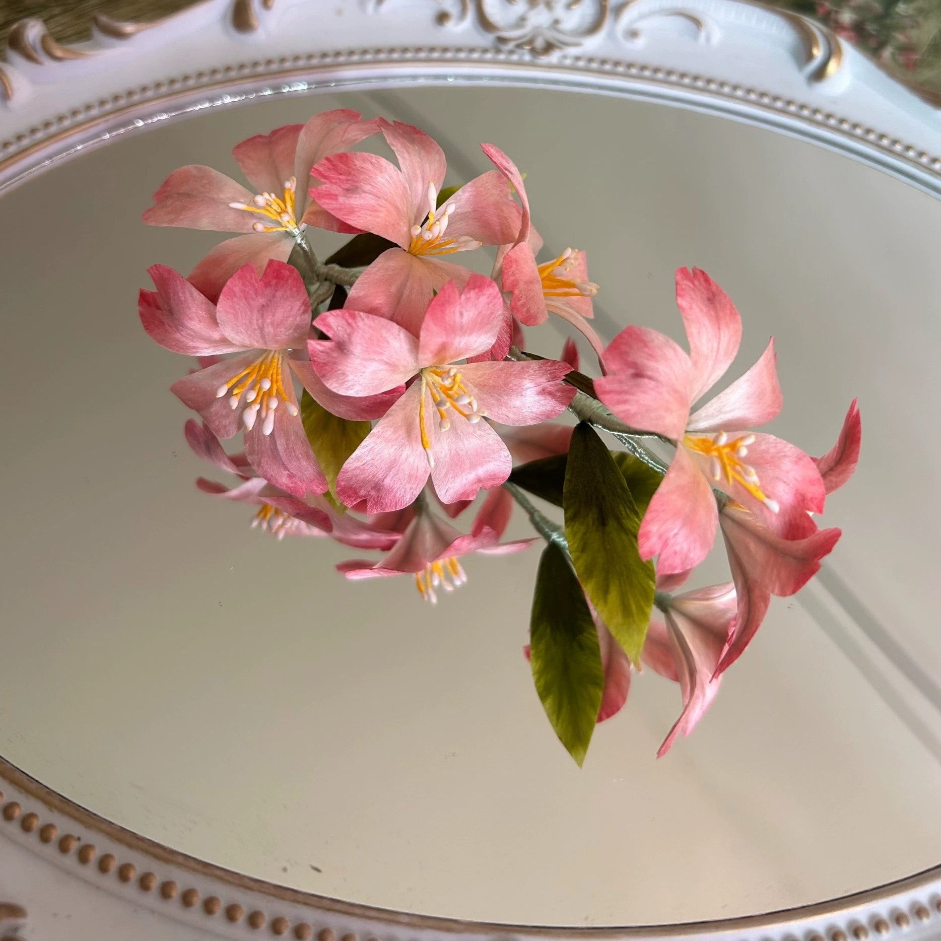 Delicate pink velvet Ronghua sakura branch hairpin displayed on elegant mirror tray