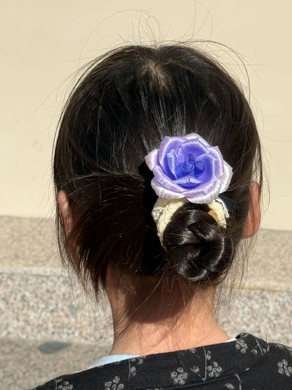 Purple-lavender Ronghua silk rose brooch worn as hair ornament in elegant low bun