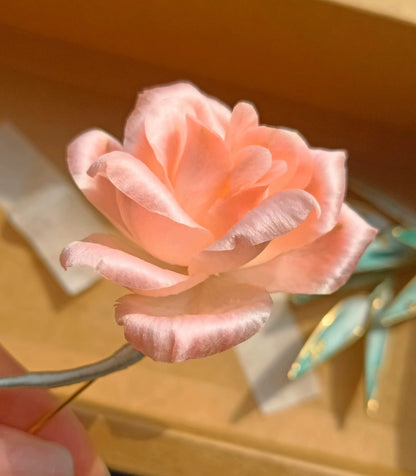 Close-up of soft pink gradient Ronghua velvet rose brooch with gold-flecked leaves