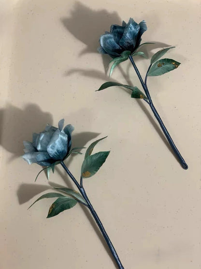 Handmade Ronghua double blue rose brooch made with natural mulberry silk thread on dark background