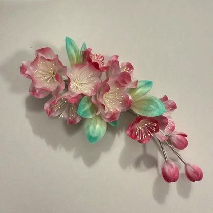 Handmade Ronghua crabapple blossom soft hair stick in pink mulberry silk on beige background