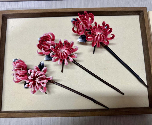 Handmade Ronghua double-head red chrysanthemum hair stick set in mulberry silk velvet flower with wooden pins and dark leaves, displayed on wooden tray