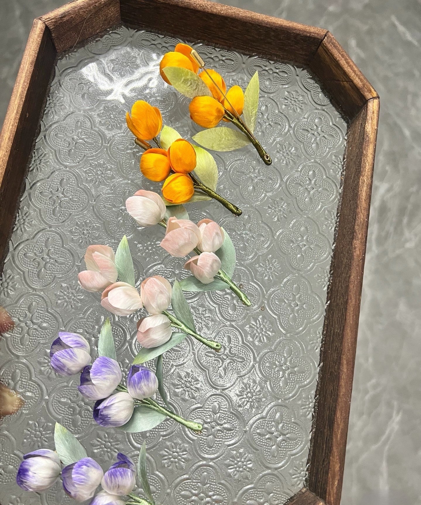 Handmade Ronghua tulip brooches in orange, pink, and lavender-purple mulberry silk velvet flowers on glass tray