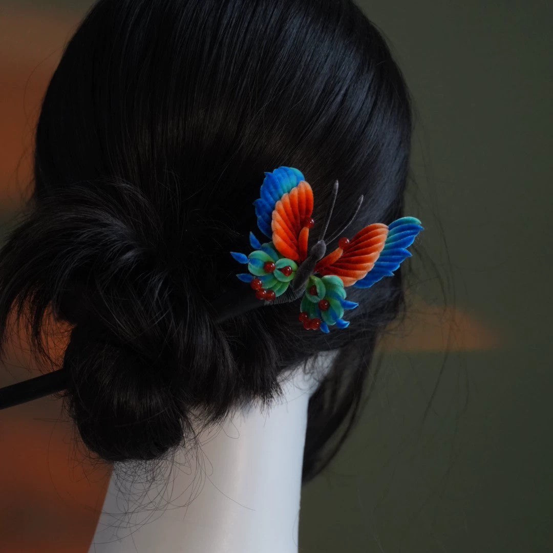 Handmade Ronghua late autumn butterfly hairpin in multicolored mulberry silk velvet on black hair stick, worn in low bun