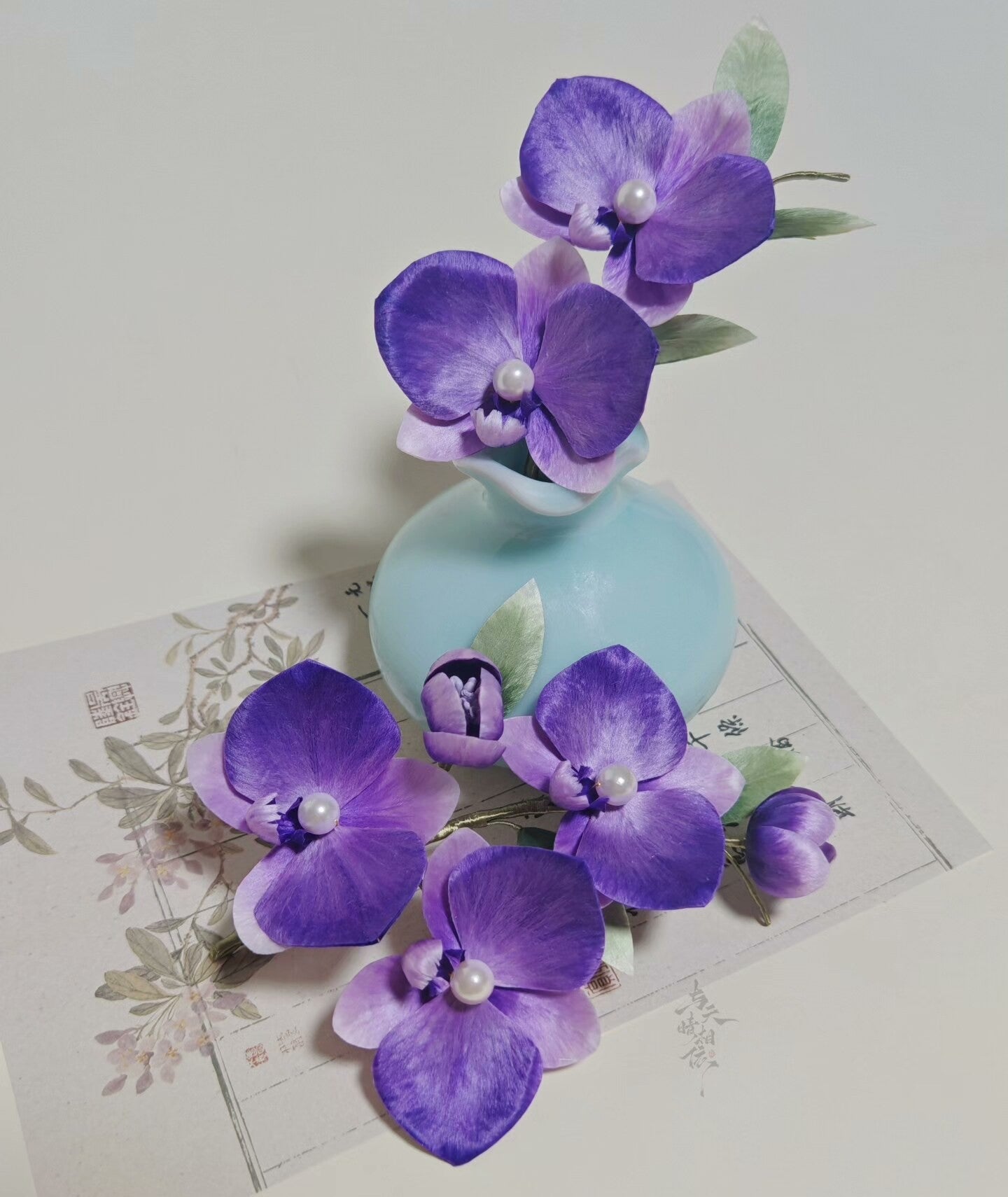 Handmade Ronghua purple phalaenopsis orchid hairpin set – large and small mulberry silk velvet orchids with pearl centers displayed with vase