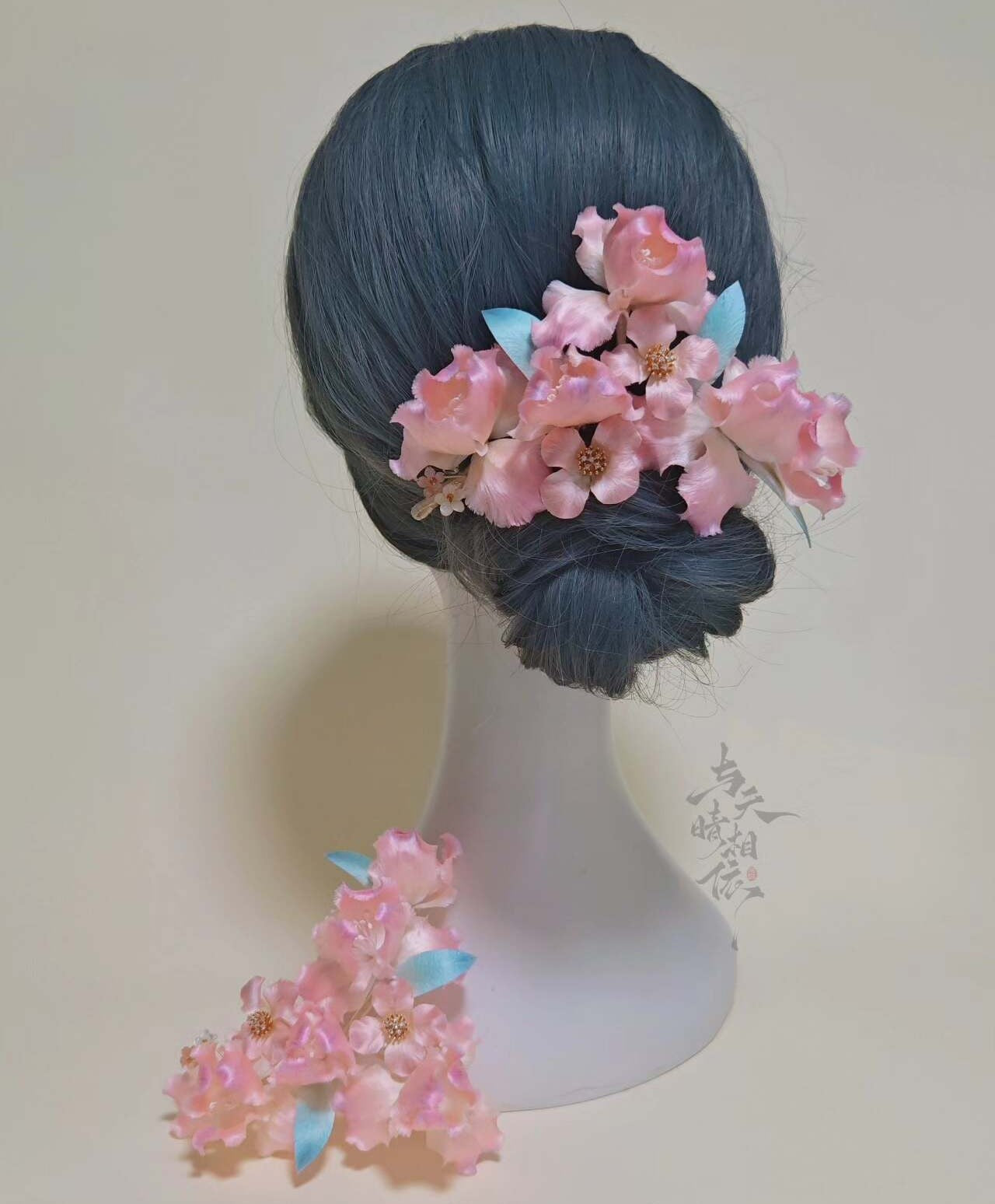 Handmade Ronghua pink iris hairpin cluster in mulberry silk velvet worn in low bun on mannequin head