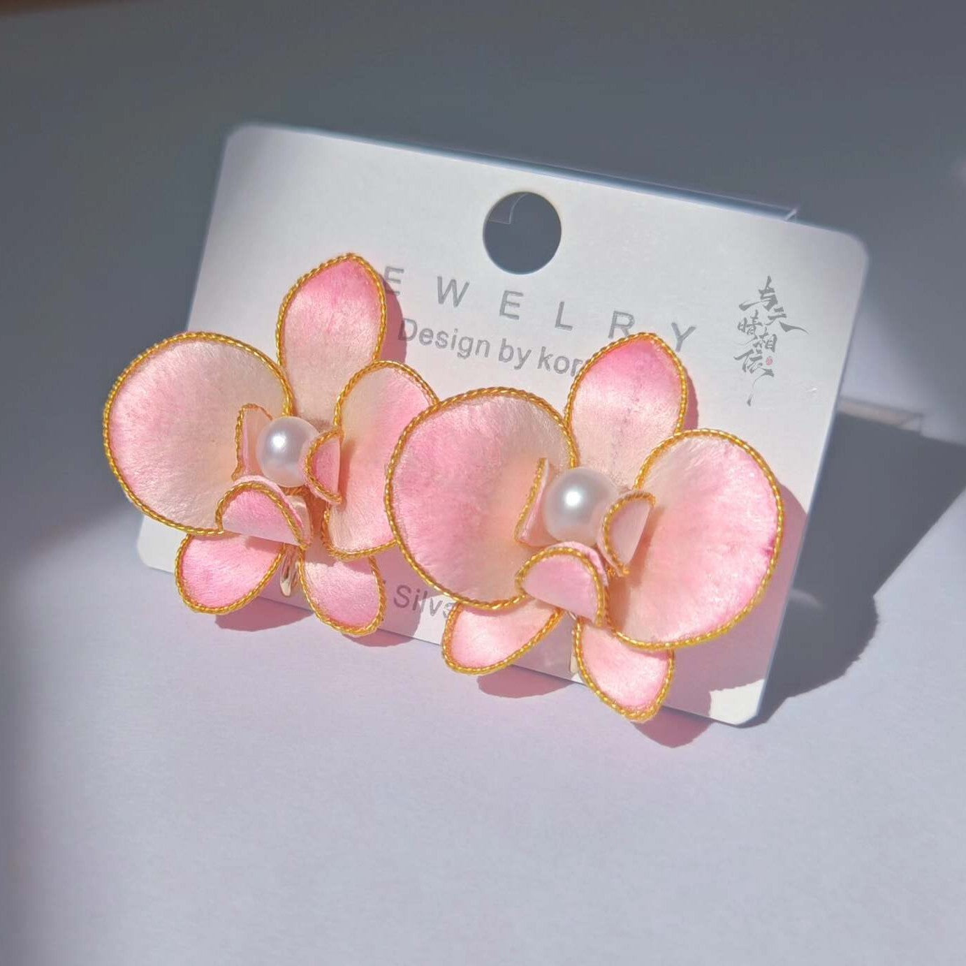 Handmade Ronghua pink phalaenopsis orchid stud earrings in mulberry silk velvet with gold edging and pearl center