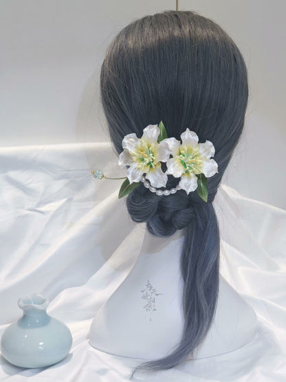 Handmade Ronghua double lily hairpin in white mulberry silk velvet with green leaves and pearl details worn in low bun