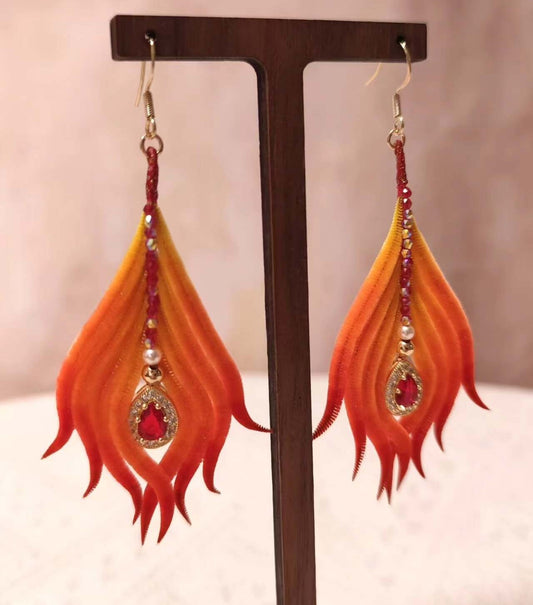 Handmade Ronghua phoenix tail feather earrings in red-orange mulberry silk velvet with crystal and pearl accents on gold hooks