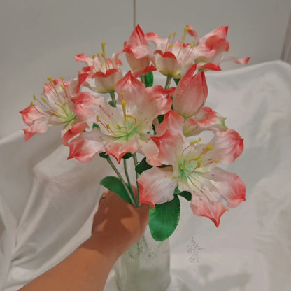 Handmade Ronghua large pink-white lily bouquet stem in mulberry silk velvet with green leaves, held in hand