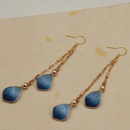 Handmade Ronghua blue waterdrop long drop earrings in mulberry silk velvet with gold chain on display