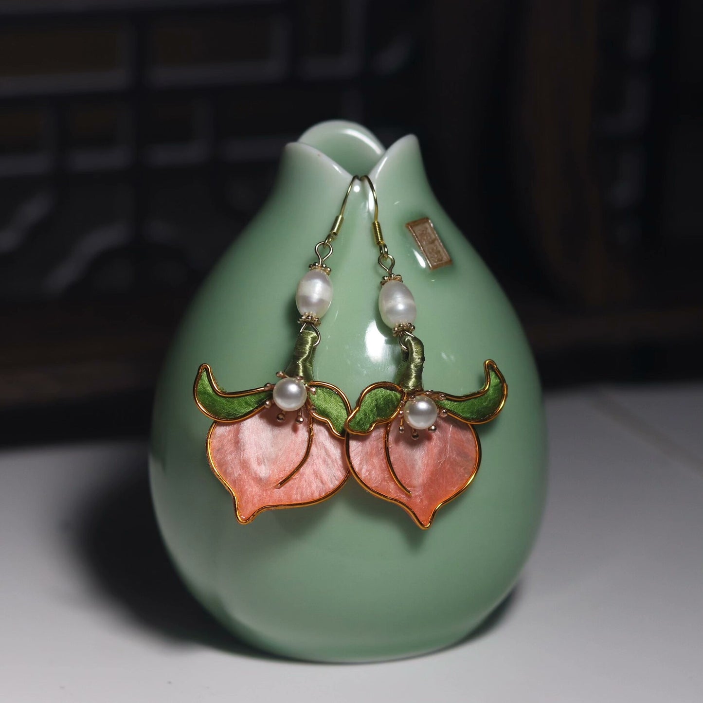 Handmade Ronghua pink longevity peach drop earrings in mulberry silk velvet with green leaves and freshwater pearl on gold hooks