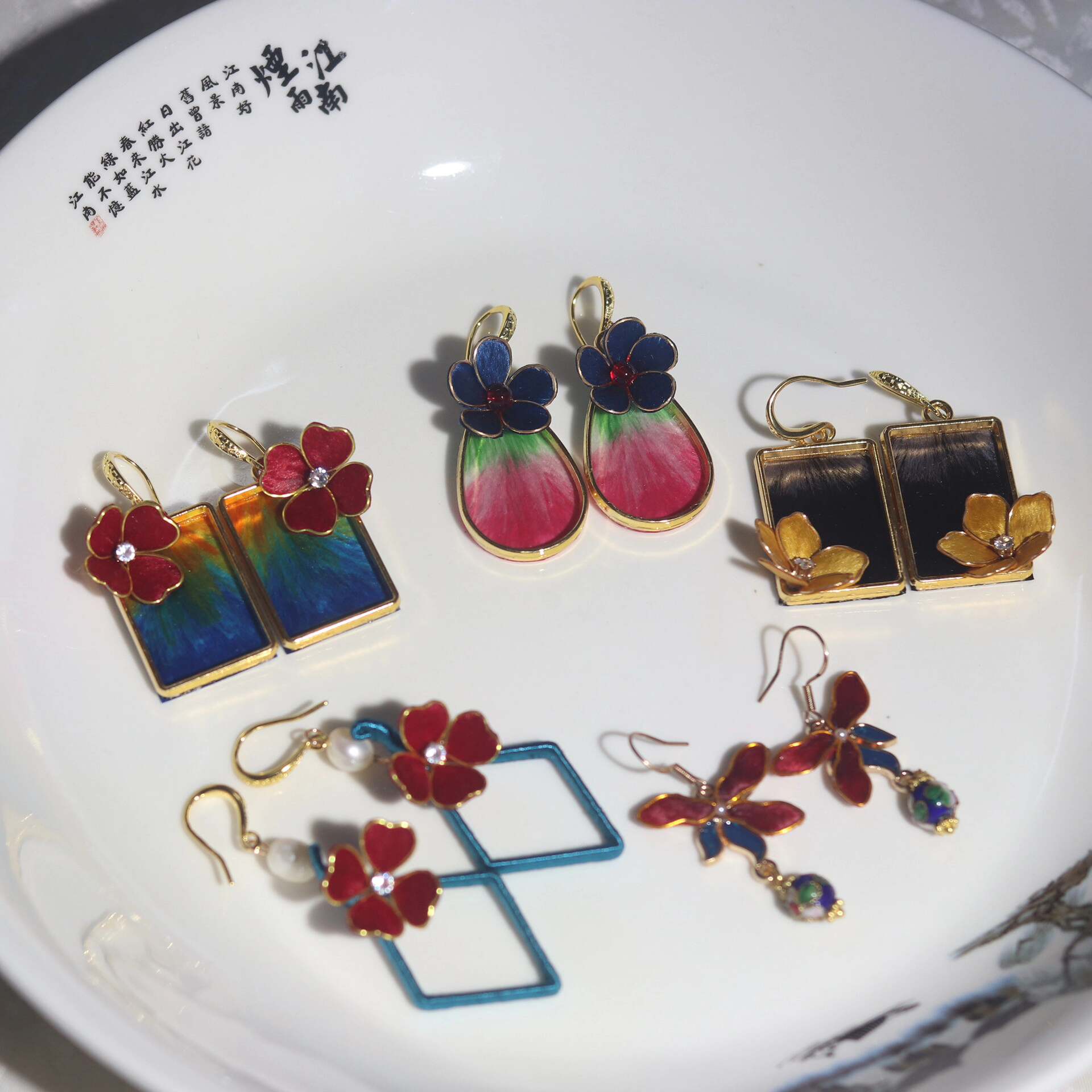 Handmade Ronghua colorful cloisonné-style earrings collection in mulberry silk velvet – various flower and gradient designs displayed on white fabric