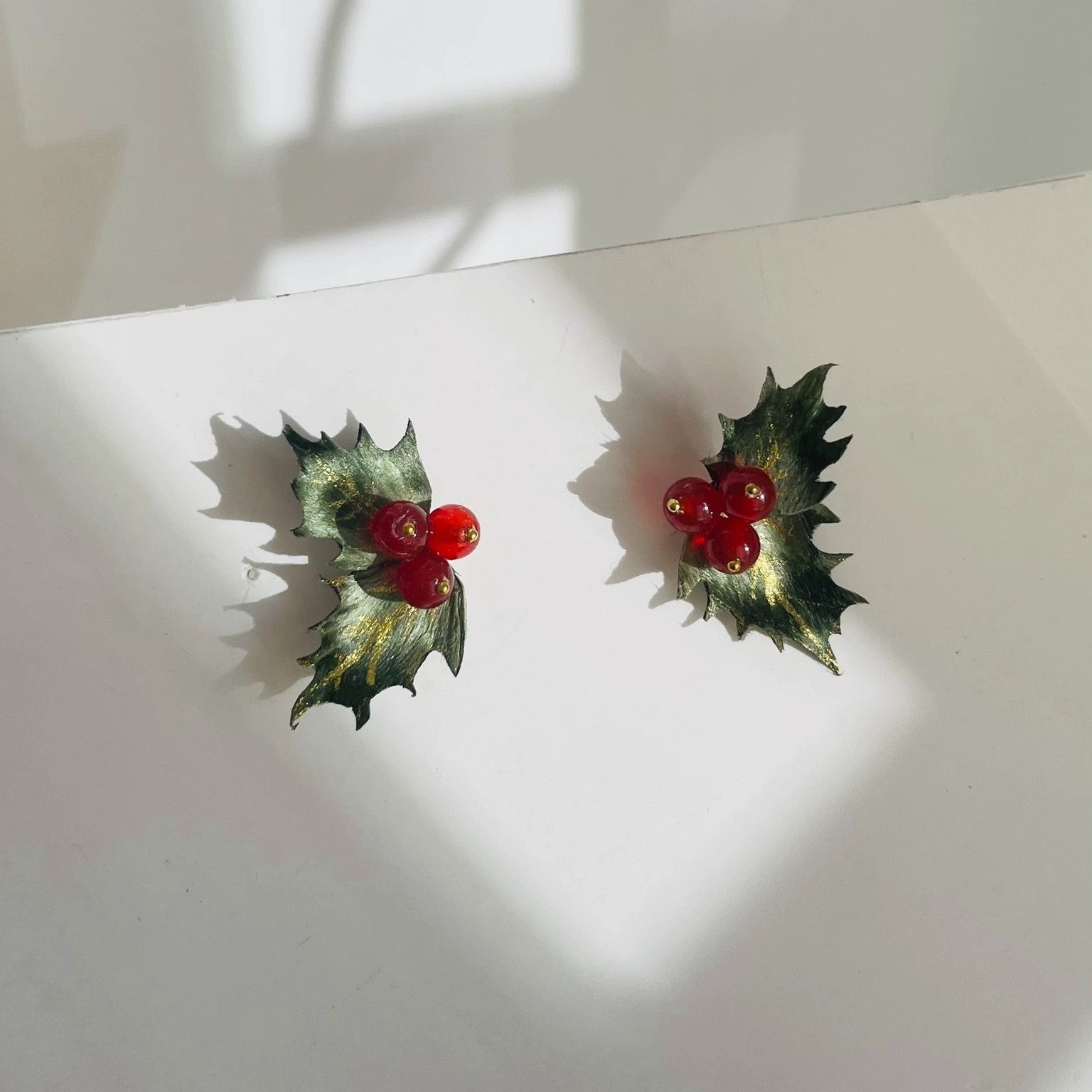 Handmade Ronghua holly leaf stud earrings in green mulberry silk velvet with red berry clusters and gold details