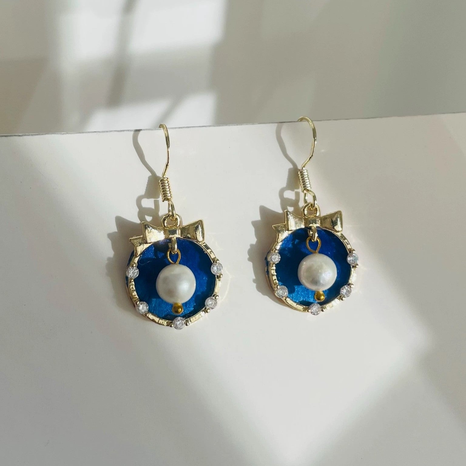 Handmade Ronghua royal blue lucky cat drop earrings in mulberry silk velvet with freshwater pearl paw and gold details