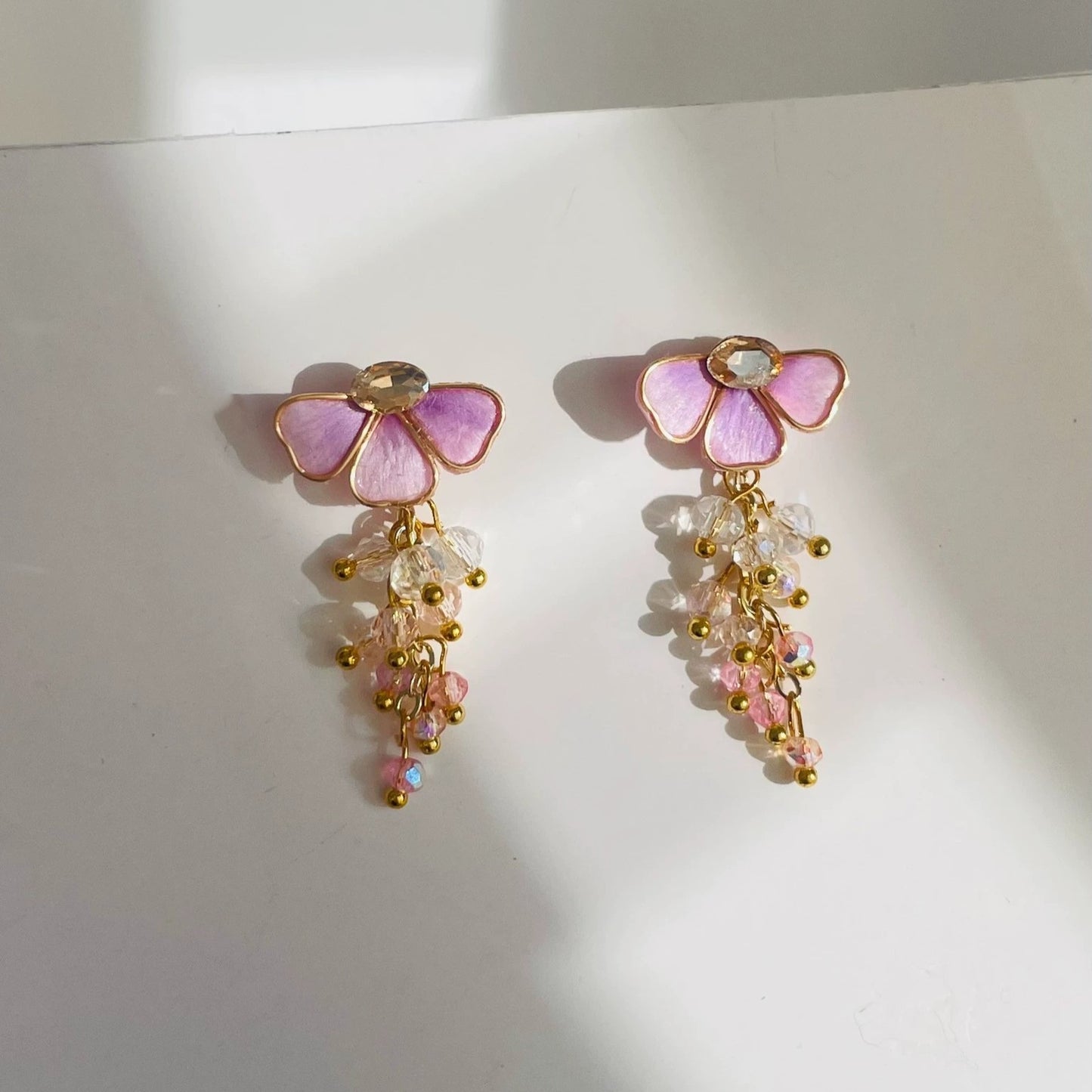 Handmade Ronghua pink wisteria tassel earrings in mulberry silk velvet with crystal bead drops and gold details